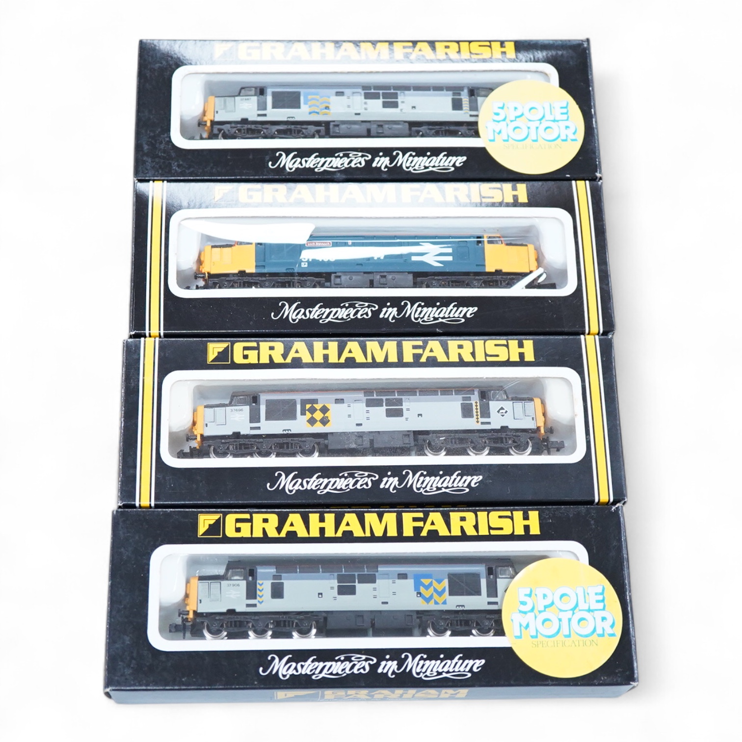 Four boxed Graham Farish N gauge railway Class 37 diesel locomotives; a BR, 37 408 (8035), a BR Coal Sector, 37696 (8036), a BR Petroleum Sector, 37 887 (8037) and a BR Railfreight Metals, 37 906 (8038).